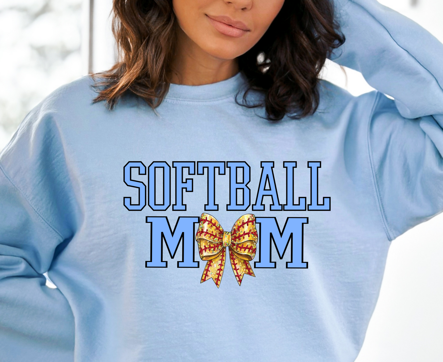 Person wearing a light blue sweatshirt with 'SOFTBALL MOM' and a butterfly graphic.