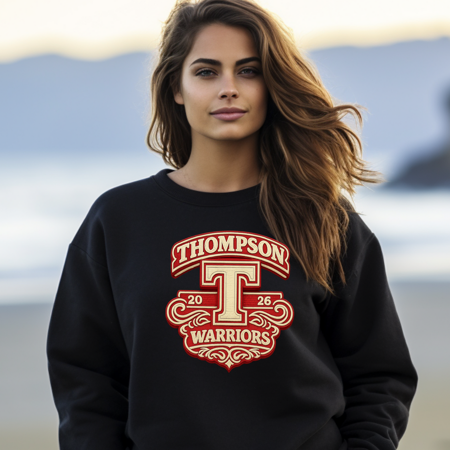Woman wearing a black sweatshirt with red and white text and logo on a beach.